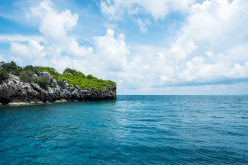 Seascape and small island with blue sky