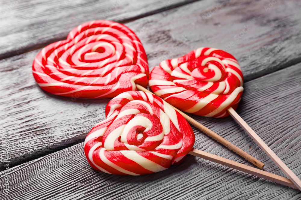 Tasty lollipops on wooden background, closeup