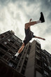 © Coka - young man doing parkour jump in the city