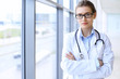 © volha_r - Medical doctor woman over clinic interiers background.