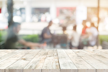 Wall Mural - empty clear white wood table for product placement or montage, perspective style. blurred people in 
