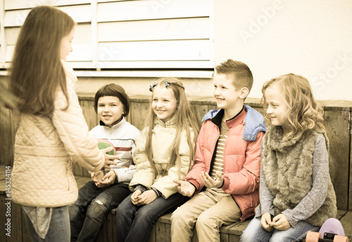 Fotografie, Obraz boys and girls play together with Ball in school yard in autumn