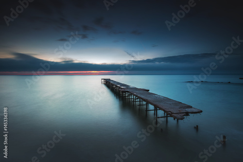 Naklejka na drzwi Old broken bridge in the sea, long exposure