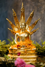 The Buddha Statue With Naga Is Decorated With Flowers