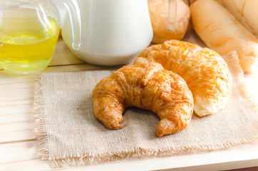 Wall Mural - Close up shot of Croissant and bekery ingredients on wooden table