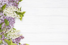 Lilac Flowers On The White Wooden Background.