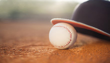 Baseball Cap And Baseball Ball On Field, Copy Space
