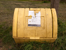 A Yellow Grit Box Outside With Its Lid Closed And On The Grass Next To A Path Winter Roads Salt Roads And Cars
