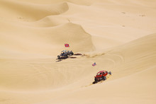 ATV Riders In The Vast Desert