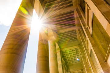 Sun Flare through European Roman Columns Historic Brown Bright