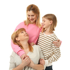 Wall Mural - Happy young woman with her mother and daughter on white background