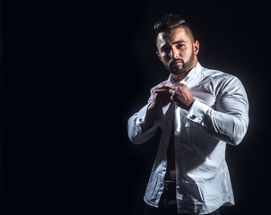 Businessman thinks in the morning. White man in white shirt on black background. Young attractive businessman thinking before work. Dream of success