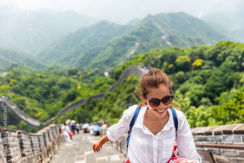 china travel at Great Wall. Tourist in Asia walking on famous Chinese tourist destination and attraction in Badaling north of Beijing. Woman traveler hiking great wall enjoying her summer vacation. - obrazy, fototapety, plakaty 