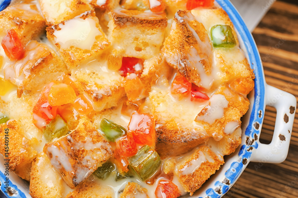 Freshly baked bread pudding in casserole dish, closeup