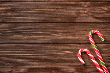 Wall Mural - Christmas candy canes on wooden background