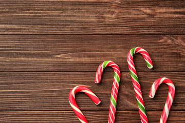 Wall Mural - Christmas candy canes on wooden background