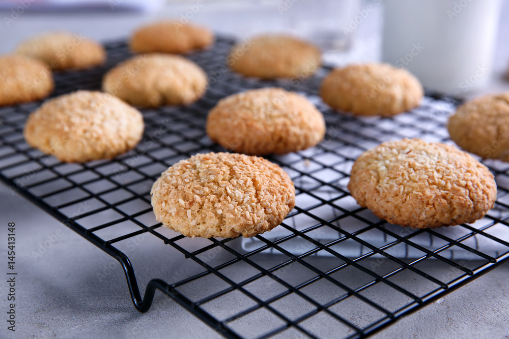 Delicious coconut cookies on baking rack, closeup
