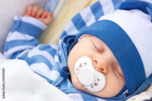 Fotomural Newborn baby with pacifier sleeping in baby pram