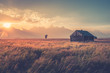 © Cole Buckhart - Old farmhouse on grassy landscape in Grand Teton National Park