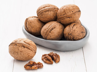 Wall Mural - inshell walnut on white wooden background