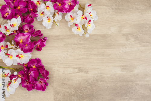 white-and-purple-orchids-on-wooden-surface