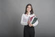 © tonefotografia - Beautiful teacher Woman holding book on grey background