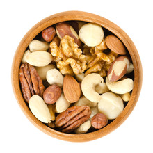Raw Mixed Nuts In Wooden Bowl. Dried Walnuts, Hazelnuts, Almonds, Cashews, Macadamia, Brazil And Pecan Nuts. Fancy Mix Of Snack Food. Isolated Macro Food Photo Close Up From Above On White Background.