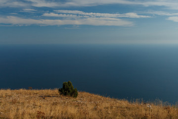  Blue sky with clouds and airplane trails over the Black sea. Nature composition in Crimea, Ukraine 2011.