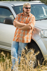 Wall Mural - Farmer in sunglasses standing near ca