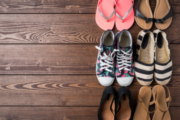 Wall Mural - Collection of women's shoes on wooden background