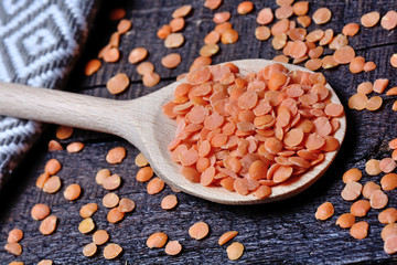 Wall Mural - Red lentils in a wooden spoon