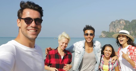 Wall Mural - man welcome people group to take selfie photo on beach on cell smart phone happy cheerful tourists o