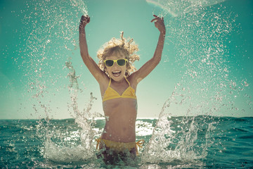 Wall Mural - Happy child playing in the sea