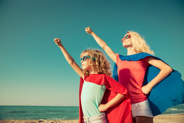 Poster - Family of superheroes on the beach. Summer vacation concept