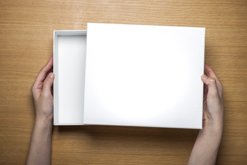 Wall Mural - woman hand hold a paper on the wood table(background)