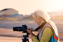 Senior Woman Doing Photography On A Beach In Florida