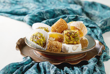Eastern Sweets. Turkish Delight With Pistachios In A Vase. The Fabric On  White Background