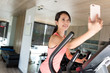 © leungchopan - Sport Woman practice on Elliptical machine and taking selfie