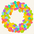 © zokka - Colorful Easter background with wreath of bright eggs confetti isolated on beige backdrop.