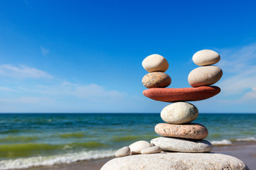 Wall Mural - Stones balance on the background of sea and blue sky