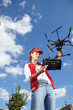 © ZoomTeam - Woman with remote control and flying surveillance drone