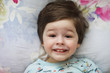 © alexkich - Portrait of a young child lying on a pillow