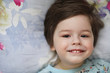 © alexkich - Portrait of a young child lying on a pillow