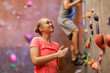 © Syda Productions - man and woman exercising at indoor climbing gym