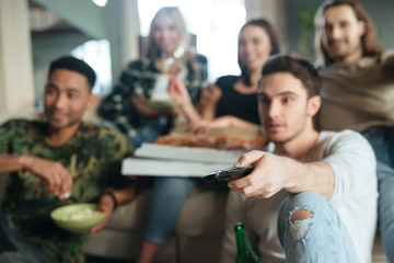 Wall Mural - Blur image of a five friends sitting with pizza