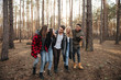 © Drobot Dean - Smiling group of friends walking outdoors in the forest.