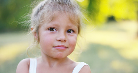 beautiful and healthy baby girl lifts thumb finger in approval. concept approval, nature and sustainability.	