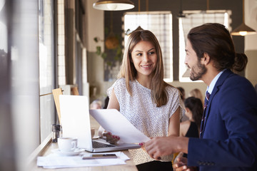 Two Businesspeople Having Informal Meeting In Coffee Shop