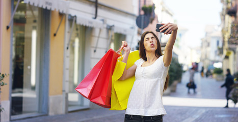 A beautiful woman taking a photo after shopping, and is very happy of their purchases in the period balances. Concept: fashion, shopping, happiness and fashion bloggers.	