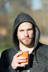 Wall Mural - man in hoodie with paper coffee, tea cup